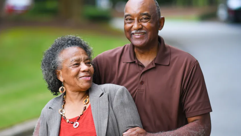 Mature couple smiling in a convertible car