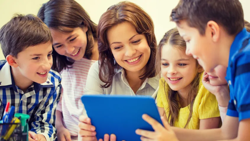 Teacher and students using a tablet