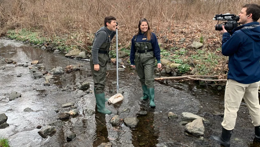 Videographer filming students at the Teaneck Creek Conservancy