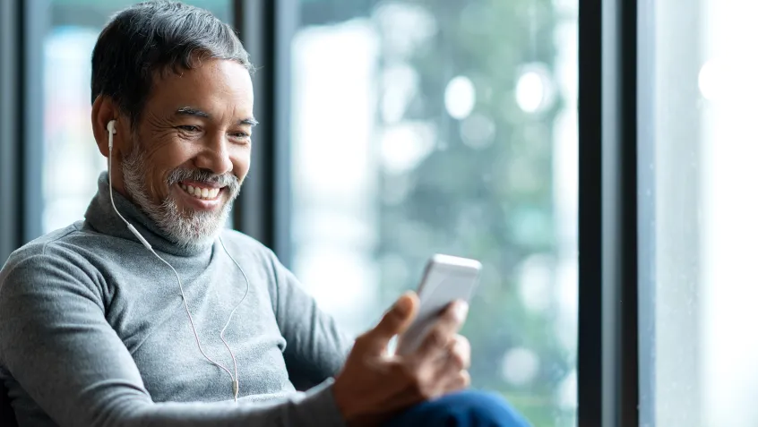 Mature man listening to headphones