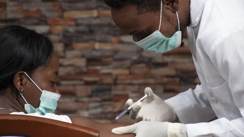 Doctor giving patient a vaccine