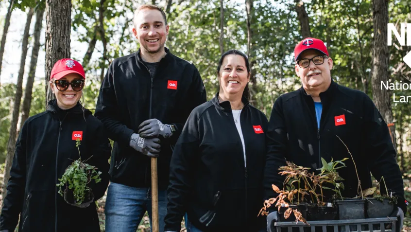 Family volunteering for NPLD event planting shrubs