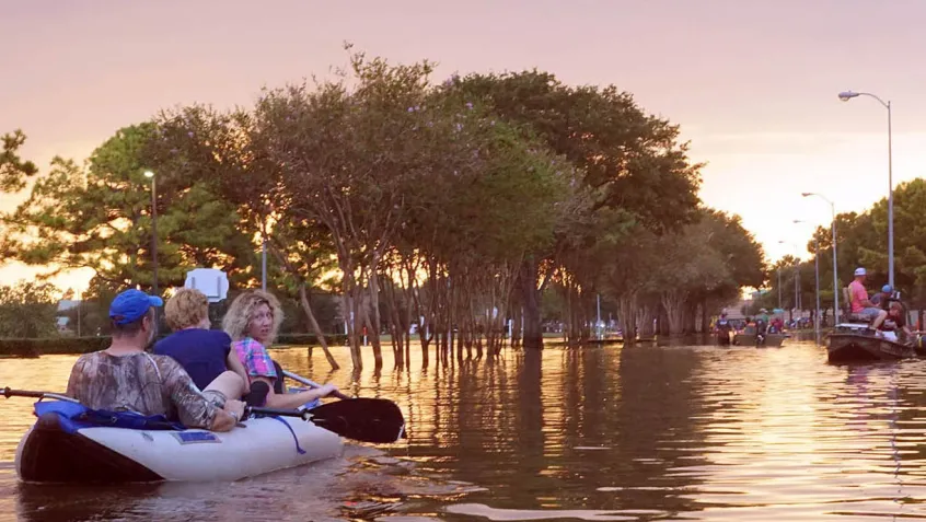 People in a canoe on a flooded city street