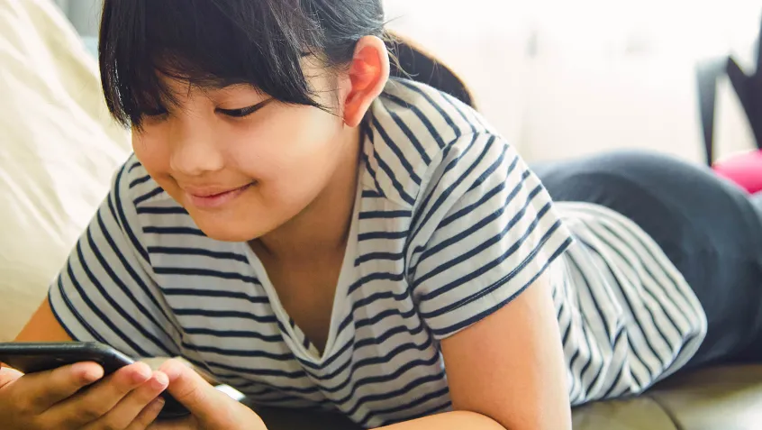 Young girl looking at a cell phone