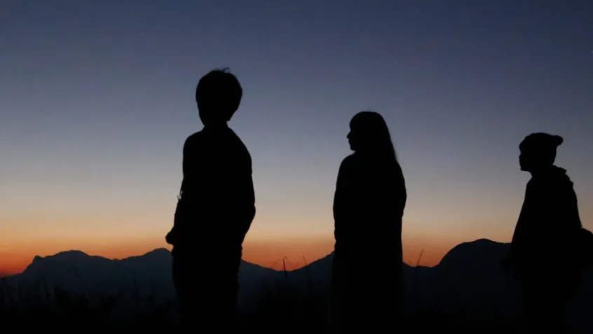 Group of youth looking at evening sky waiting for stars