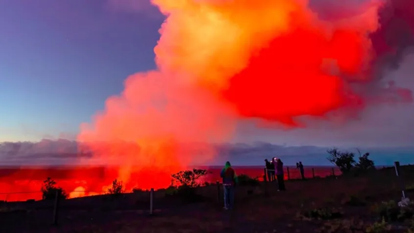 people taking pictures of a  smoldering volcano