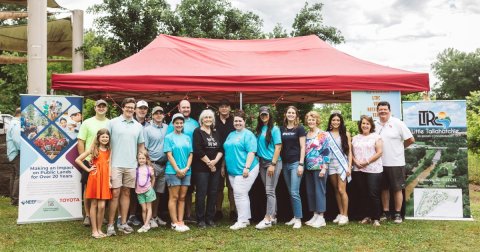 a group of officials from Toyota, NEEF and Park Along the River stand together at the Parkapalooza event in New Albany, MS