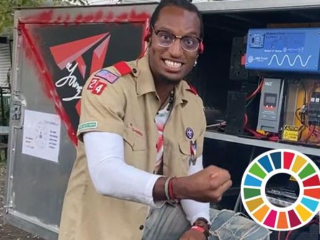 AY Young in front of his solar powered vehicle