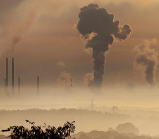 Factories billowing smoke into the atmosphere