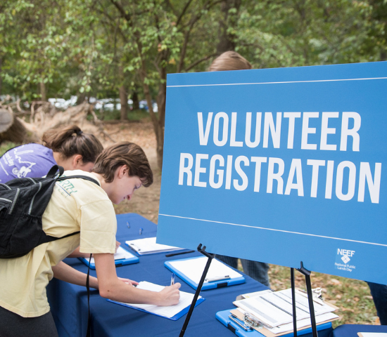 Two young women signing up for an NPLD volunteer event