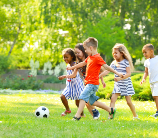 Children outdoors playing soccer