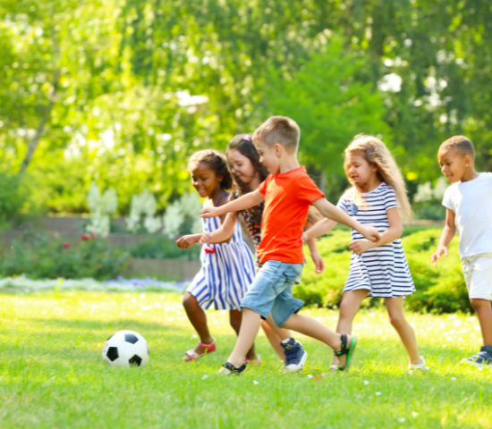 Children outdoors playing soccer