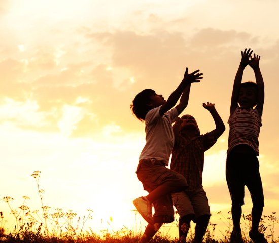 Children playing outside at dusk