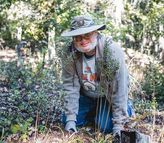 Man planting flowers at volunteer event