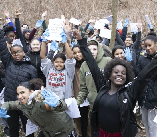 Students celebrating a finished project outdoors