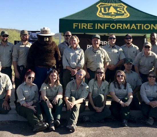 US Forest service officials group picture with Smokey the Bear