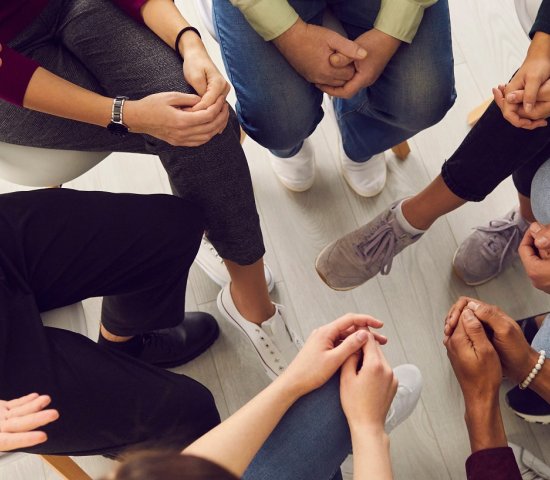 People sitting in a circle talking.