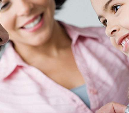 Pediatrician and young patient with parent