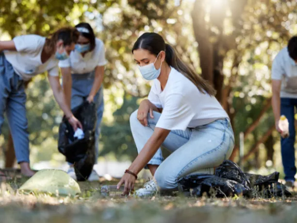 Woman wearing mask during an outdoor cleanup