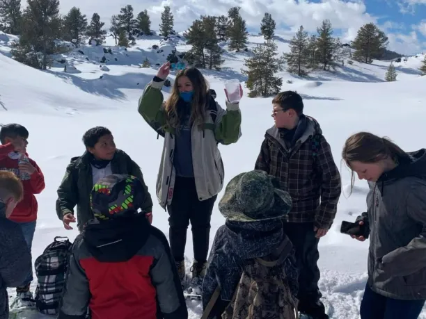 Teacher outdoors in the snow with students