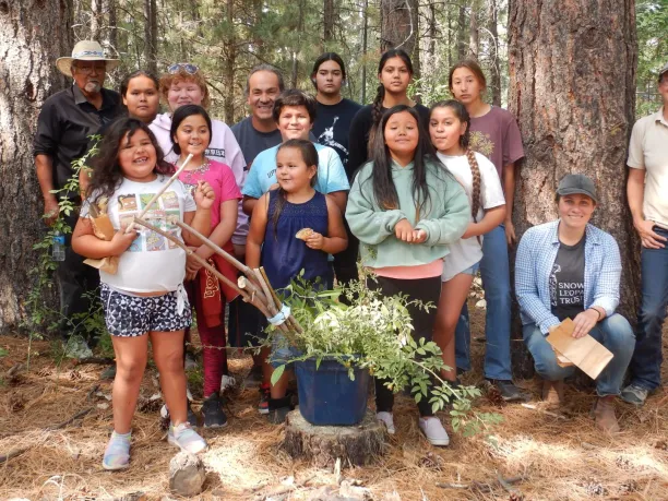 a group of native american youth stand together for a photo during a seed collection project