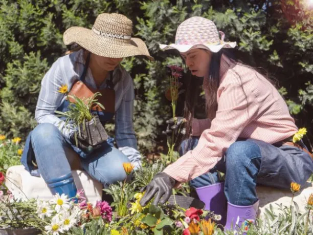two women work getting their spring garden ready during Earth Month