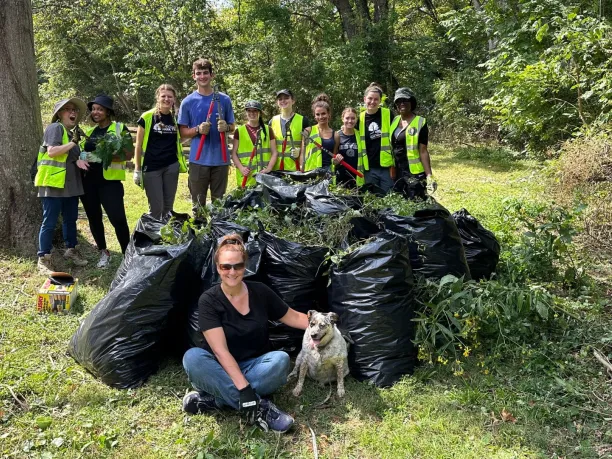 volunteers standing around a mound of trash bags after collecting invasive species on National Public Lands Day