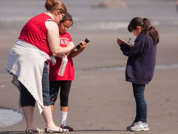 Greening STEM kids collecting data at the shore