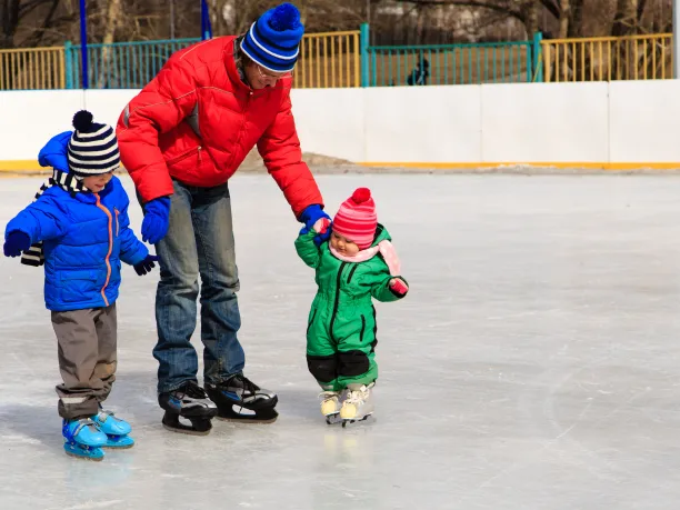 Dad skating with his kids