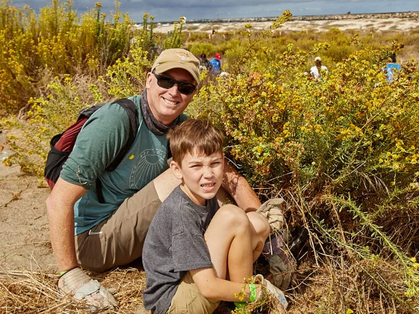 Dad and son planting at San Diego River Mouth