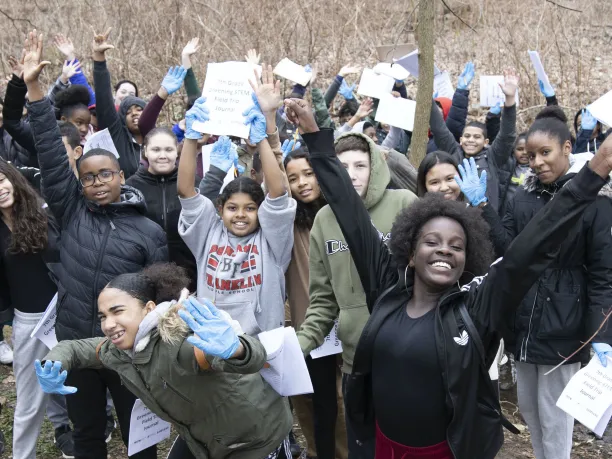 Students celebrating a finished project outdoors