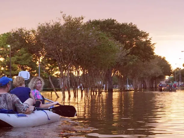 People in a canoe on a flooded city street