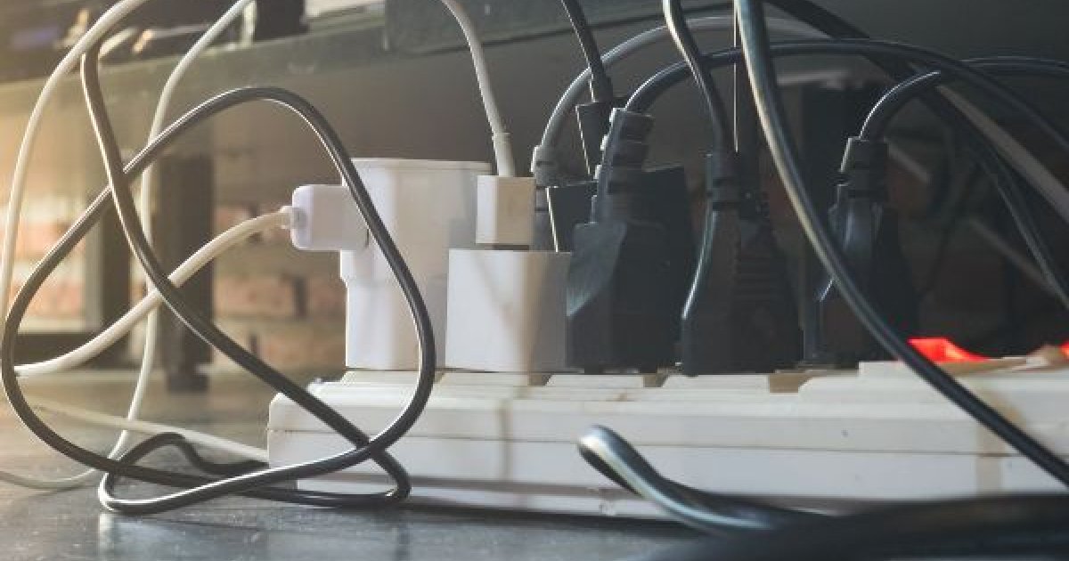 an electrical outlet power cord full with plugs