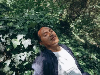 Photo of man relaxing in nature for his mental health