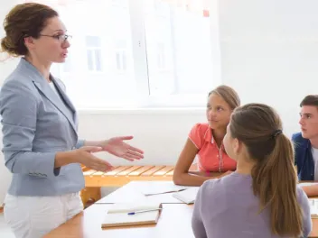 Teacher talking to a group of teens