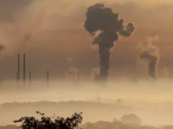 Factories billowing smoke into the atmosphere