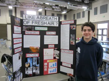 Student showing a science project about air quality during wildfires