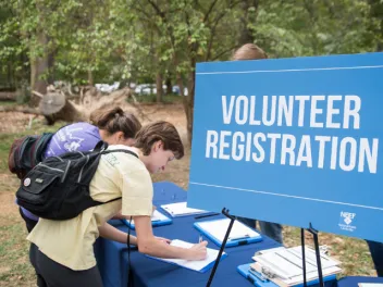 Two young women signing up for an NPLD volunteer event