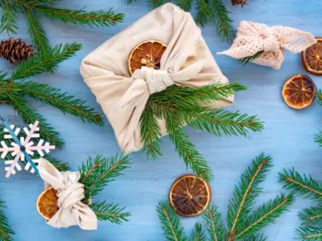 Zero waste gifting wrapping using cloth wrap, dried oranges and pine tree sprigs