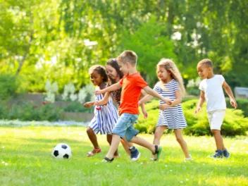 Children outdoors playing soccer