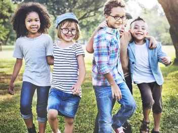 Five smiling children outdoors