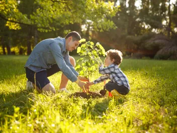 Parent and child planting tree