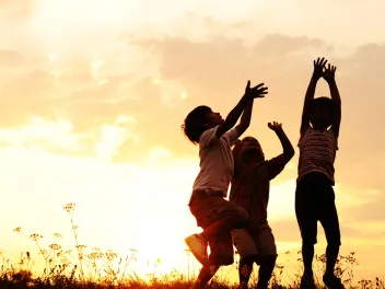 Children playing outside at dusk