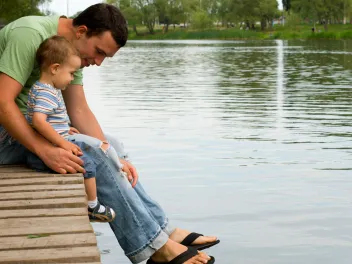 Father and son at the pond