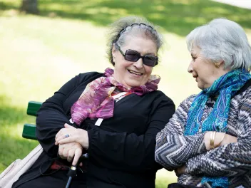 Two senior ladies having a conversation in a park