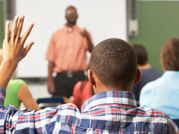 Student raising hand in class