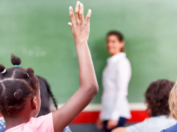 Student raising hand in class