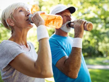 Older people hydrating at the park