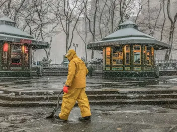Man shoveling snow at a public park