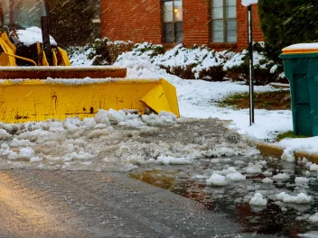 Truck shoveling snow off street